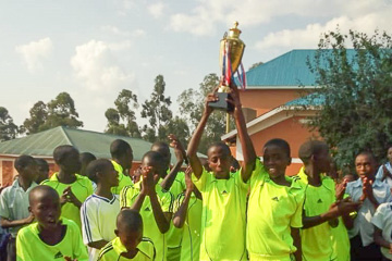 Kirima children with football trophy